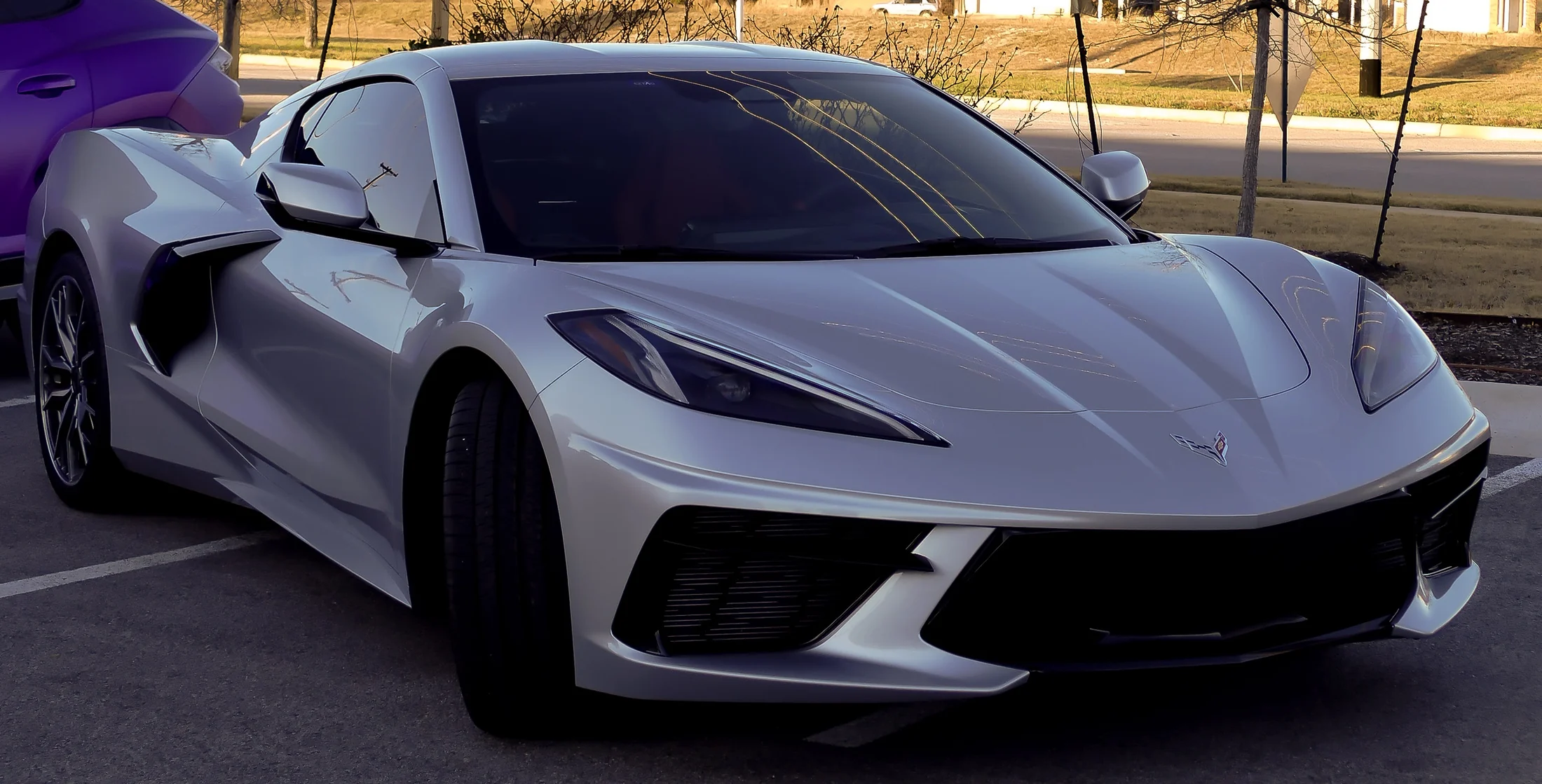 White mid-engine sports car parked outdoors