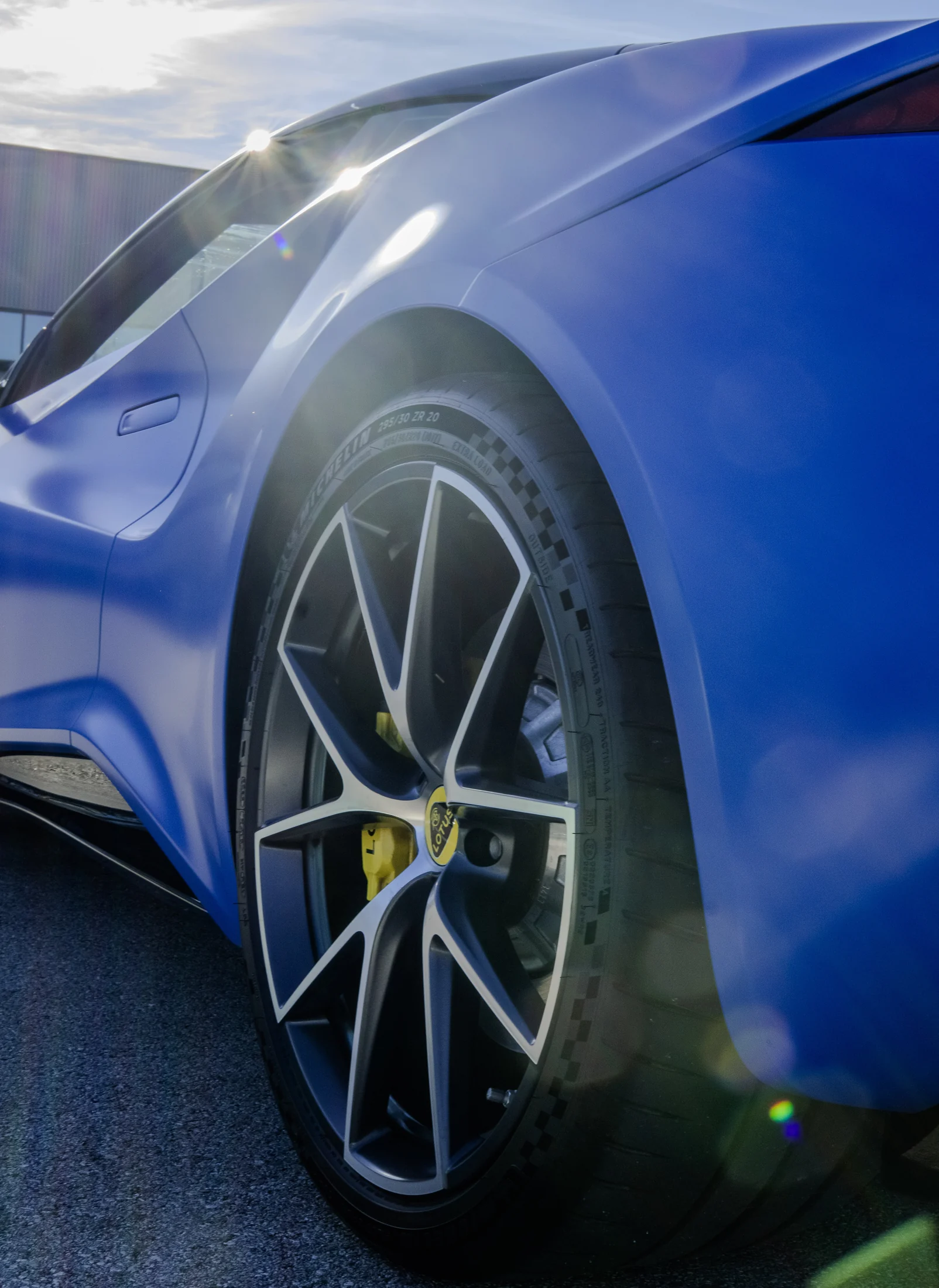 Blue supercar wheel in sunlight