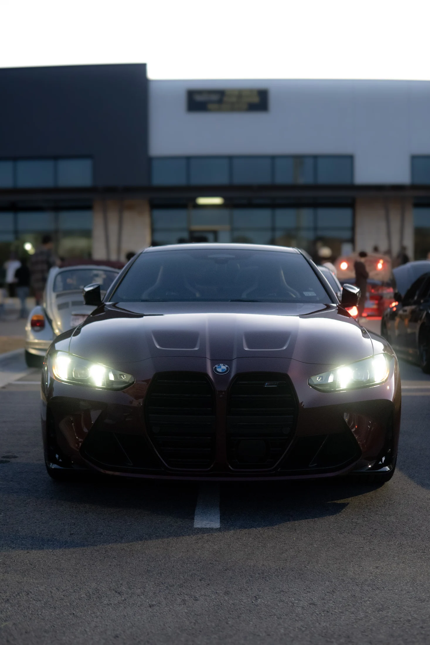 Black BMW photographed head-on at dusk