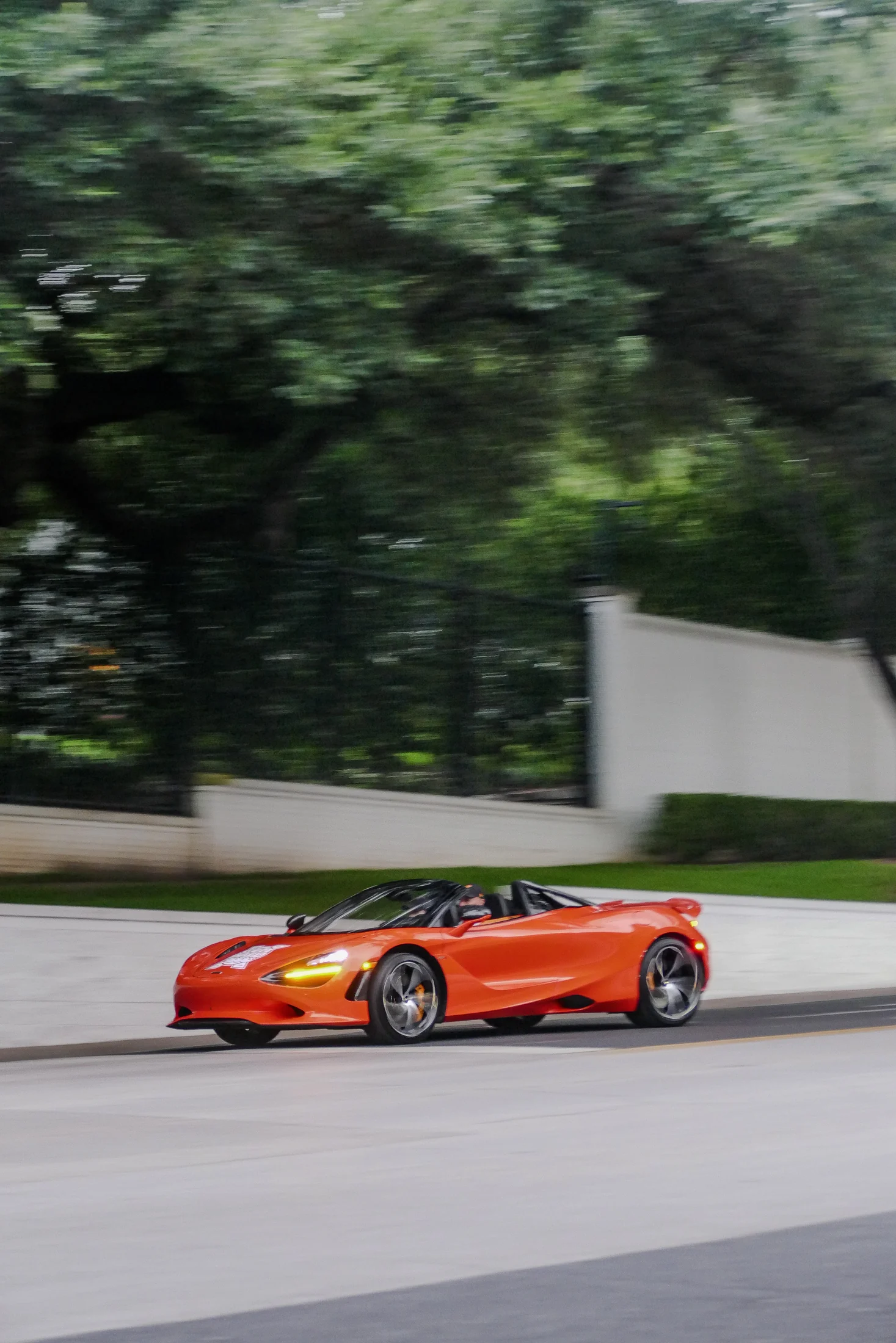 Orange McLaren photographed in motion