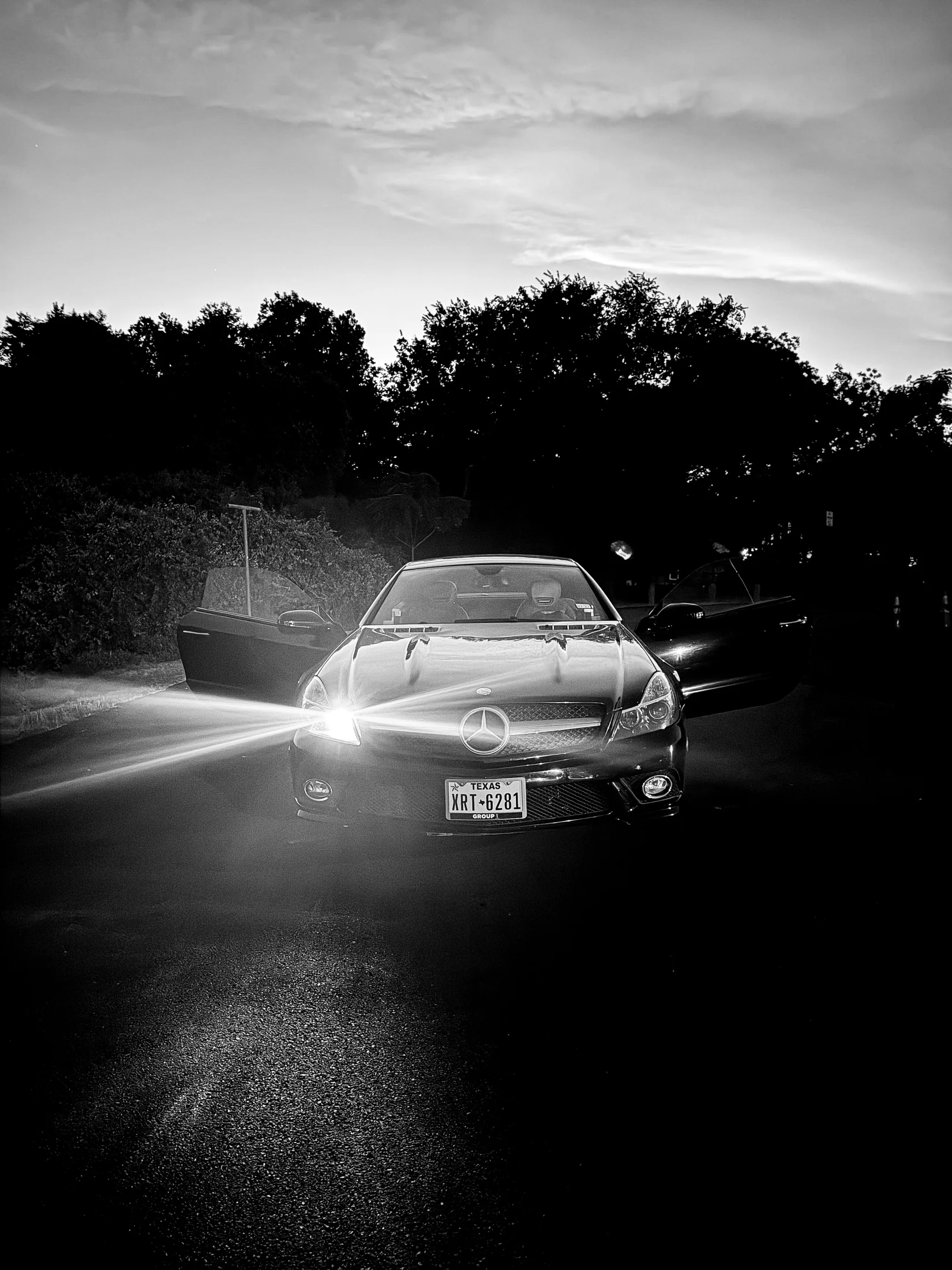 Black Mercedes photographed with headlights on